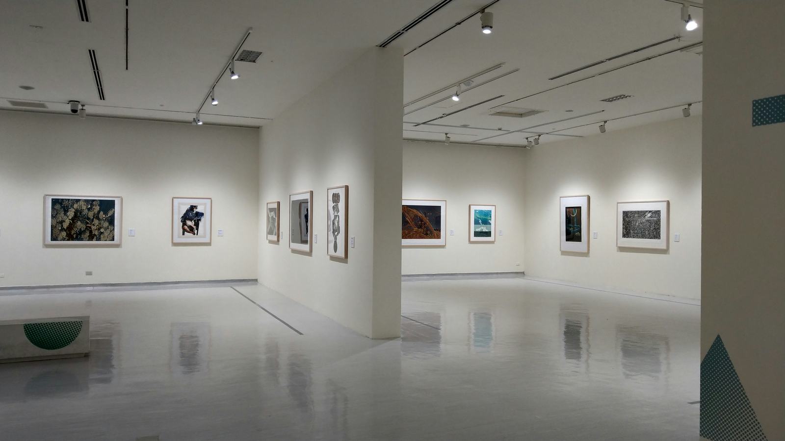 Modern gallery with artworks on white walls